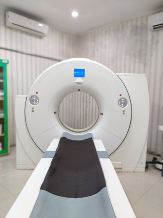 Modern CT scan machine in a medical diagnostic room. This advanced imaging device uses X-rays and computer technology to produce detailed internal body images for accurate diagnosisの写真素材