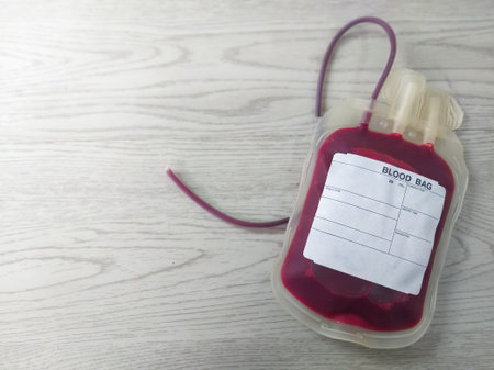 A single blood donation bag with a label for patient and donor information, used in transfusion and medical procedures. Essential for safe blood storage. Copy space and isolated.の写真素材