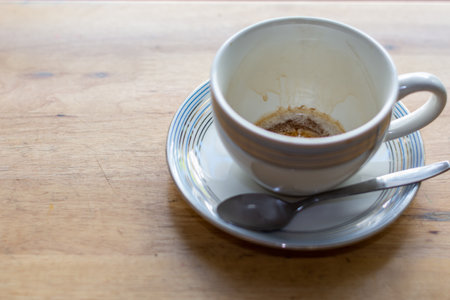 Empty coffee cup after drink on wood table.の写真素材
