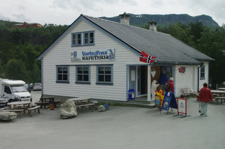 A cafe and souvenir stall in Norway where you can see the flag of the country, advertising spots and some parked carsのeditorial素材