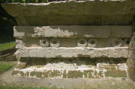 Mayan structures in Chichen Itza where you can see the pyramid and some symbols, this on a sunny day with some cloudsの写真素材