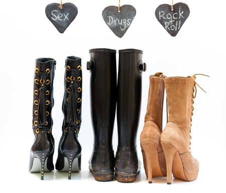 Three pairs of shoes depicting sex, drugs and rock