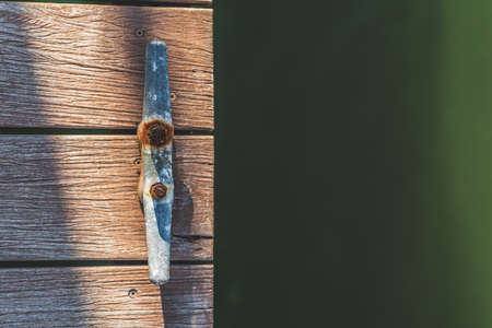 Overhead shot of Rusting mooring cleat on dock with copy spaceの写真素材