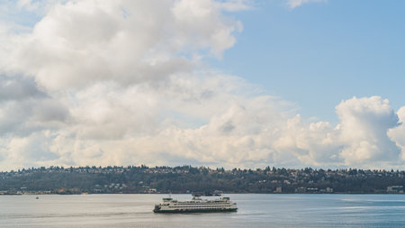 Washington Ferry sails on Elliot Bay with West Seattle and Cloud sky backgroundのeditorial素材