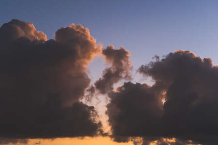 Dark and moody clouds at sunsetの写真素材