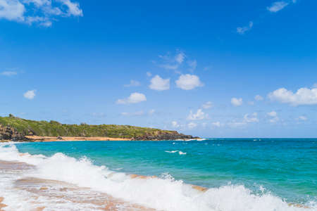 Panoramic view of tropical Red sand beach and blue water against skyの写真素材