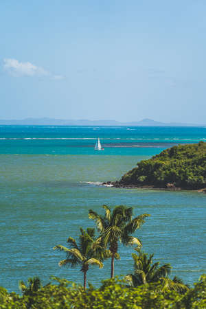 Sailboat in distance in Caribbean Sea off coast of Puerto Ricoの写真素材