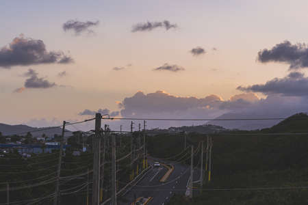 Colorful sky at dusk clouds above road and powerlines in Fajardo Puerto Ricoの写真素材