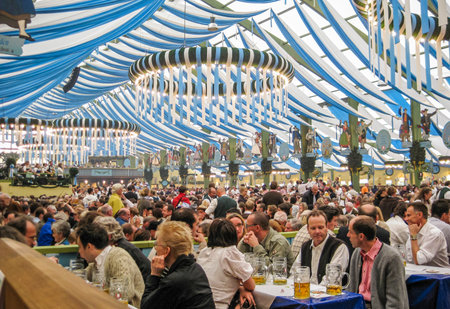Festive crowd at Munich Oktoberfest in spatenbrau Ochsenbraterei tentのeditorial素材