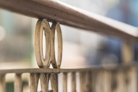 white ornamental cast iron forged railing background focus Close up