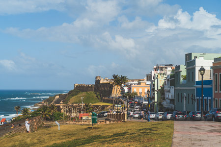 Cars along street in Old San Juan colorful buildings Castle of San Cristobalのeditorial素材