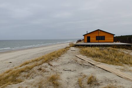 Wooden house, standing on the high Bank of the Baltic sea in the national Park \"Curonian spit, the Kaliningrad region, Russia.のeditorial素材