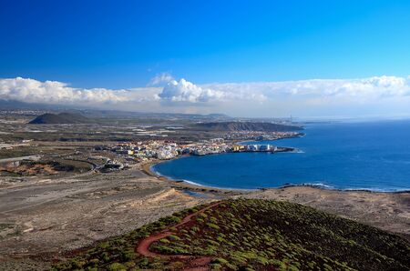 View of the city of El Medano with the top of the mountain Punta Roja, Tenerife, Canary Islands, Spain.の写真素材