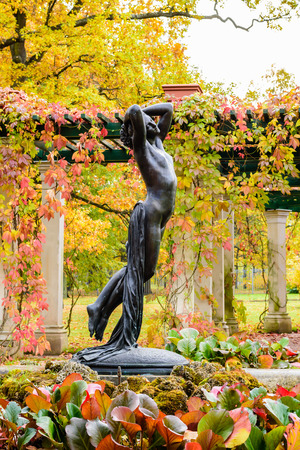 Beautiful sculpture of a woman in the autumn Park, St. Petersburg, Russia.の写真素材