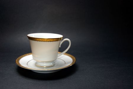 Teacup and Saucer on Black Backgroundの写真素材