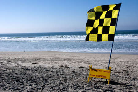 Swimming or surfing sign with flag in southern californiaの写真素材