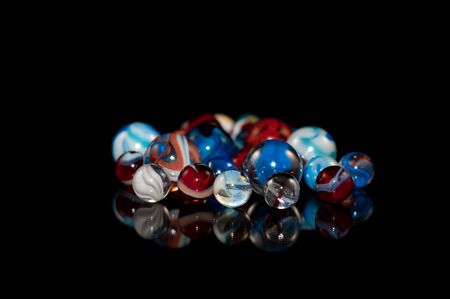 Group of marbles made of glass with swirls and various colorsの写真素材
