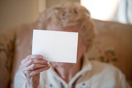 Post Card being held by elderly womanの写真素材