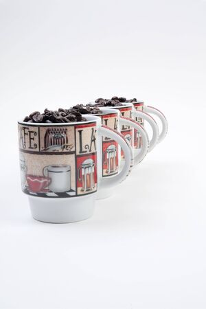 Coffee mugs filled with coffee beansの写真素材