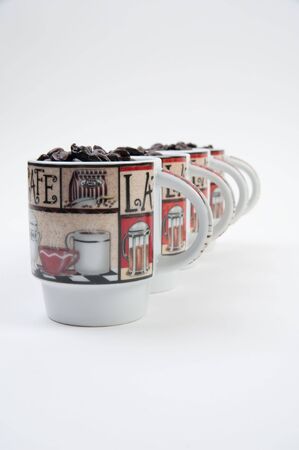 Coffee mugs filled with coffee beansの写真素材