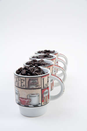 Coffee mugs filled with coffee beansの写真素材