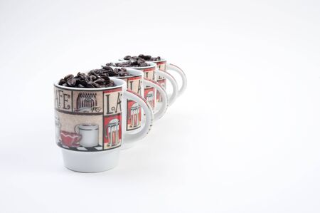Coffee mugs filled with coffee beansの写真素材