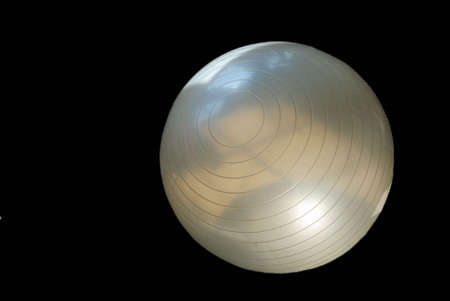 White exercise ball on black backgroundの写真素材