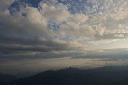 Evening sky with clouds over the mountainsの写真素材