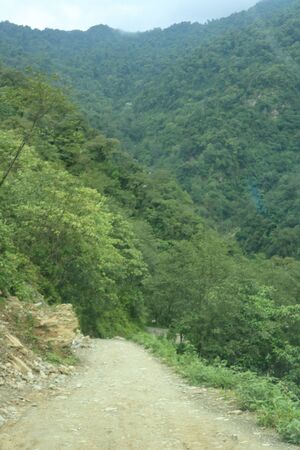 A road on the mountain with heavy cloudy sky over in Sikkim, Indiaの写真素材