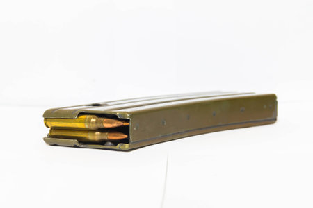 Sizes 5.56 mm rifle bullets magazine containing 30 shots on a white background.