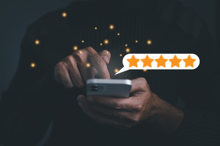 Business concept. Customer man hand pressing on smartphone screen with gold five star rating feedback icon and press level excellent rank for giving best score point to review the service.の写真素材