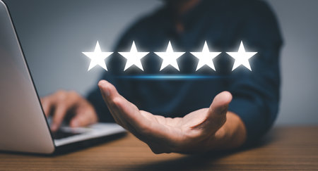 hand of customer or client holding the stars to complete five stars. with copy space. giving a five star rating. Service rating, satisfaction concept.の写真素材