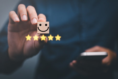 customer services best excellent business rating experience. Satisfaction survey concept. Hand of a businessman chooses a smile face on wood block cube. 5 Star Satisfaction.の写真素材