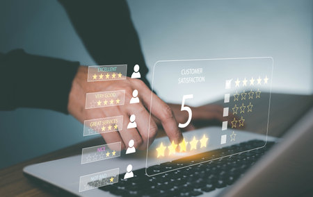 Man hand using computer Notebook with popup five star icon for feedback review satisfaction service,User gives rating to service experience on online application, Customer review satisfaction feedback survey concept,の写真素材