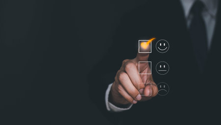 Satisfaction and Customer service concept ,Business man are touching the virtual screen on the happy Smiley face icon to give satisfaction in service. rating very impressed.の写真素材