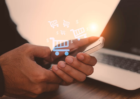 Hand of young business using smart phone with shopping cart icon, Online shopping and e-commerce concept.の写真素材