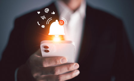 Smartphone with notification, Hand of young business using mobile phone with bell ringing for online alert, Online communication concept.の写真素材