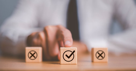 Checkmark and cross icons on wooden cubes on white background. Regulatory compliance, project feasibility concept. Tick and cross signs,approve and disapprove symbols.の写真素材