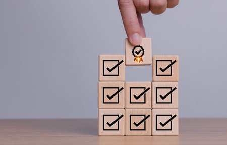 Corporate regulatory and compliance. Quality control management, ISO certification. Product, service quality warranty. Checklist survey and assessment process. Wooden cube with check mark iconの写真素材