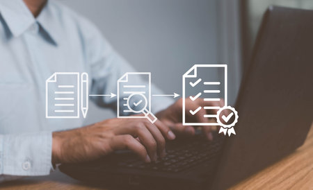 Businessman using laptop to tick mark on virtual document for online approve paperless quality assurance and ERP management, Prepare check and approve concept. Document management, paperless.の写真素材