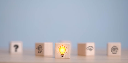 Wooden cube block which print screen lightbulb icon on face with gear, creative idea and innovation concept.の写真素材