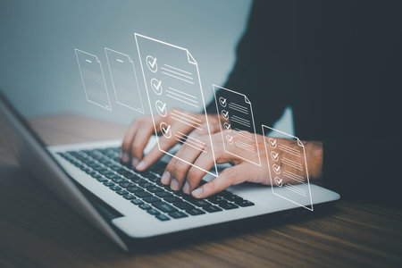 Document control and management concept, Businessman review procedures through the use of laptops and show digital checklist documents in hand technology on digital document paperless operationの写真素材