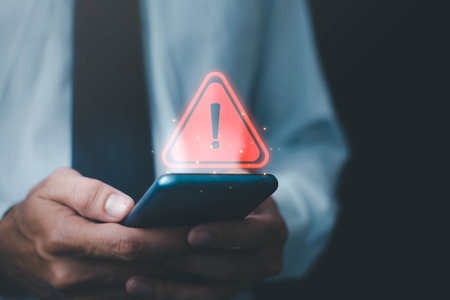 Businessman or it staffs, programmer, developer using computer laptop with triangle caution warning sign for notification error and maintenance concept. Virus detected warning, Cybercrime protectionの写真素材