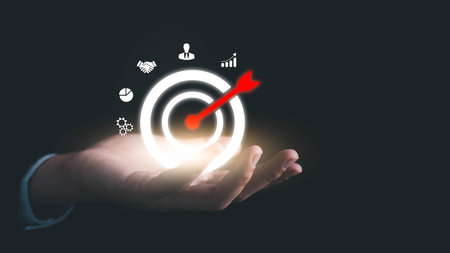 Concept of business strategy and future sustainable business finance action plan. Hand holding target board for creative and set up business objective target and success and business goals concept.の写真素材