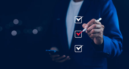 Businessman tick correct mark to approve document iso checklist icon.checkmark quality management quality assurance or QA and quality control or QC and improvement, Standardization and certification.の写真素材