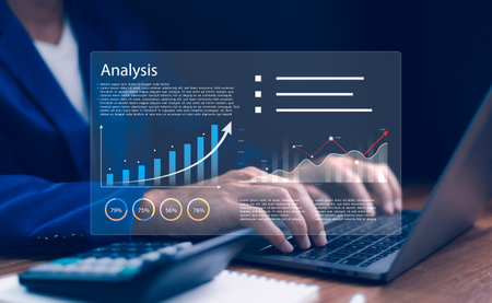 Businessman working on a laptop with virtual dashboard displaying Analysis and data charts, graphs growth. Business analytics, financial planning, digital marketing, technology for decision making.の写真素材