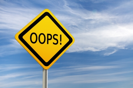 A yellow warning sign with the "OOPS!" text against blue sky.の写真素材