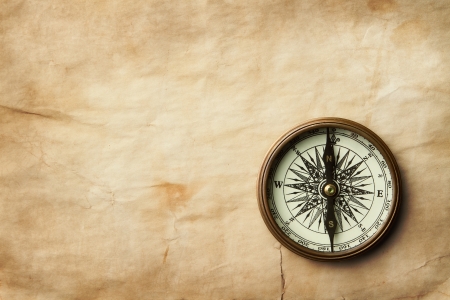 Vintage compass on old paper sheet with copy spaceの写真素材