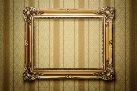 Grunge gold wooden frame on striped wallpaper