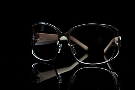 Elegant sunglasses on black backgroundの写真素材